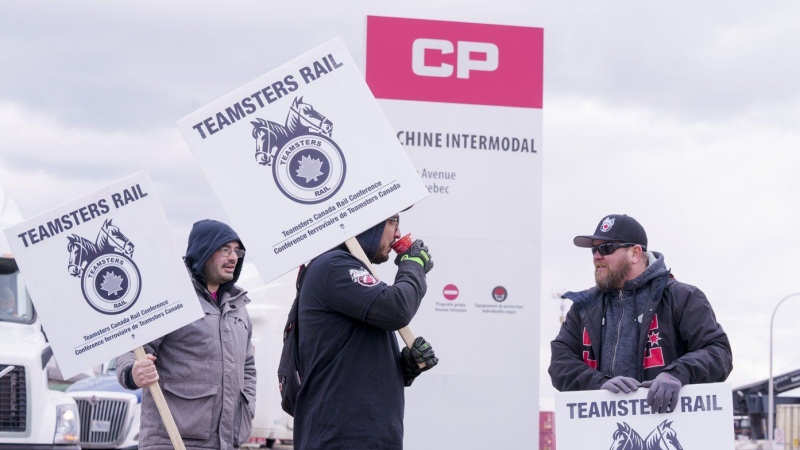 Striking rail workers walk the picket line in Montreal on March 21, 2022. THE CANADIAN PRESS/Paul Chiasson