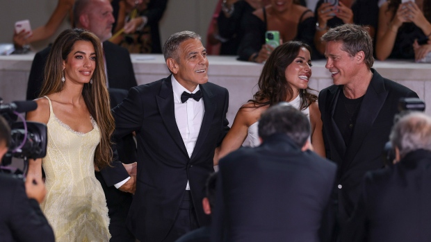 Amal Clooney, from left, George Clooney, Ines de Ramon, and Brad Pitt pose for photographers upon arrival for the premiere of the film 'Wolfs' during the 81st edition of the Venice Film Festival in Venice, Italy, on Sunday, Sept. 1, 2024. (Photo by Vianney Le Caer/Invision/AP)