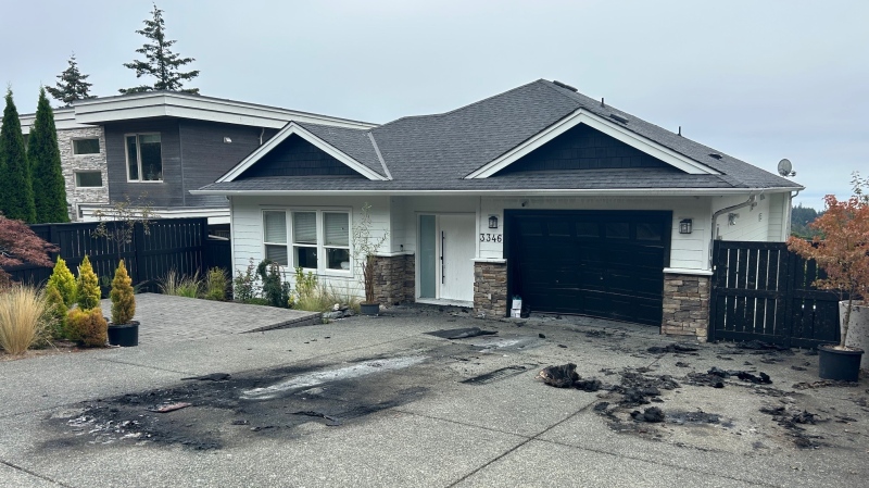 Bullet holes and the charred remains of two vehicles were apparent outside the Colwood, B.C., home on Sept. 3, 2024. (CTV News)