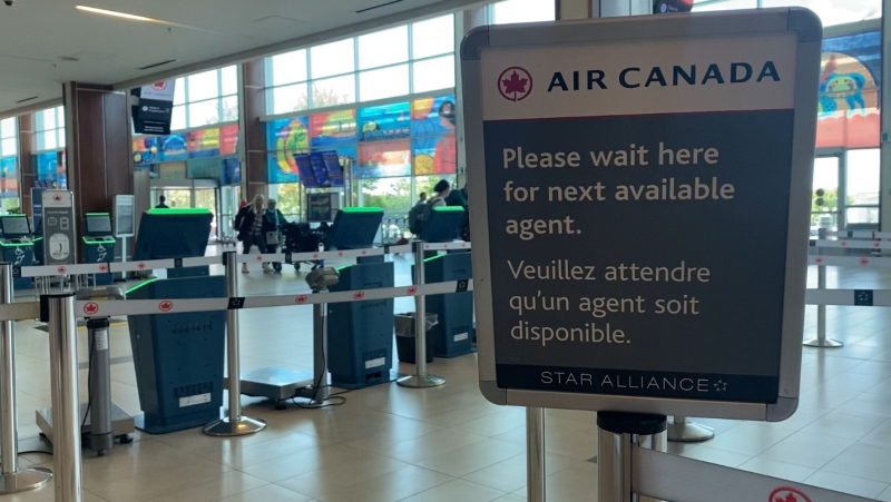 An Air Canada sign at an airport advises travellers to wait for the next available agent. (Source: Hafsa Arif/CTV News Atlantic)