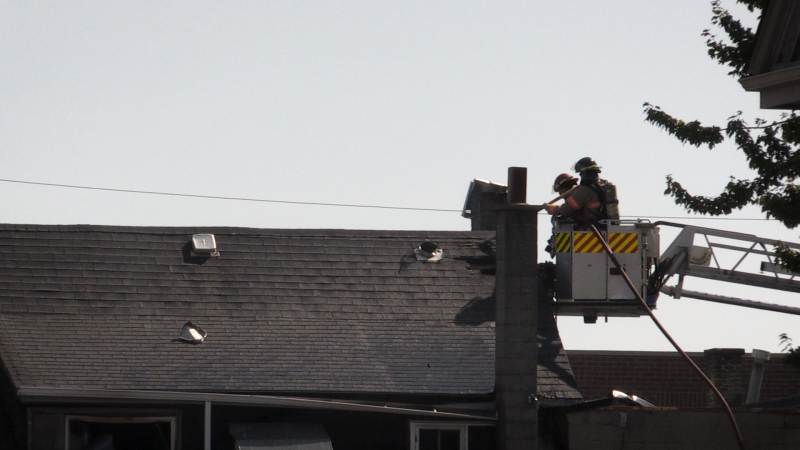 Firefighters scope the attic of a building at the corner of Dundas and Hewitt Streets for hotspots in an aerial truck, September 5, 2024 (Bailey Shakyaver/CTV News London)