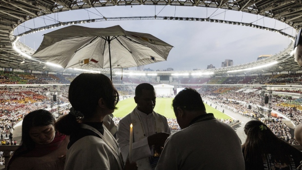 A priest gives Holy Communion to the faithful during a holy mass led by Pope Francis at the Gelora Bung Karno Stadium, in Jakarta, Thursday, Sept. 5, 2024. (Yasuyoshi Chiba/Pool Photo via AP)