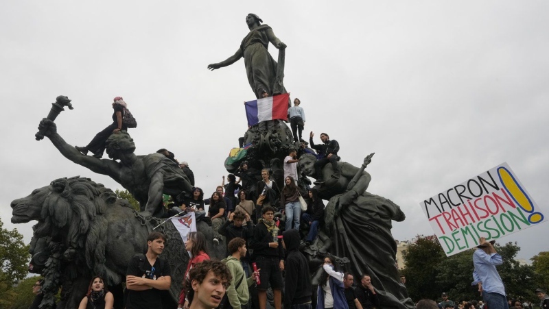 Demonstrators gather under the statue of Marianne, a symbol of the French Republic, during a protest demonstration in Paris, France, Saturday, Sept. 7, 2024. (AP Photo/Michel Euler)