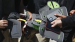 A student uses their cell phone after unlocking the pouch that secures it from use during the school day at Bayside Academy, Aug. 16, 2024, in San Mateo, Calif. (Lea Suzuki/San Francisco Chronicle via AP, File)