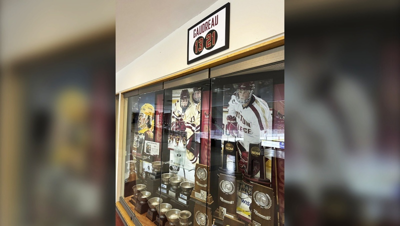 A sign hangs above the trophy case at Boston College's Conte Forum mourning the deaths of former Eagles hockey players Johnny and Matthew Gaudreau in Boston, Wednesday, Sept. 4, 2024. (AP Photo/Jimmy Golen)