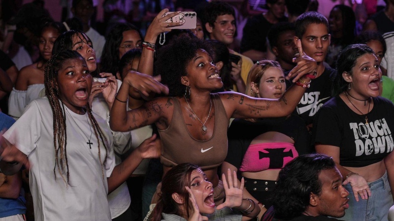 Youths react as they watch dancers participate in a K-pop contest at a cultural house in Havana, Cuba, Saturday, Sept. 7, 2024. (Ramon Espinosa/AP Photo)