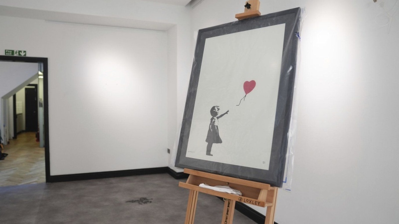 2 men charged with stealing a famous Banksy image from a London art gallery