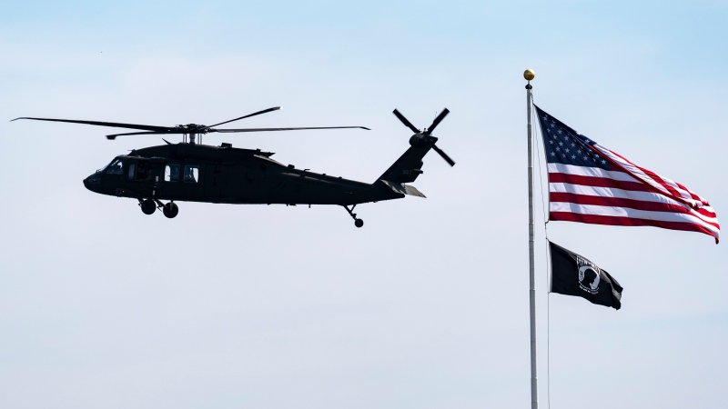 A Blackhawk helicopter approaches for landing past an American flag and POW/MIA flag at the Pentagon, Tuesday, July 23, 2024, in Washington. (Alex Brandon / AP Photo)