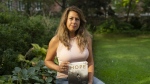 Barbara Adhiya, poses for a photo with her latest book titled, "Hope by Terry Fox" in Toronto on Sept. 13. THE CANADIAN PRESS/Paige Taylor White