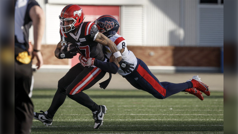 Montreal Alouettes' Nafees Lyon (8) tackles Calgary Stampeders' Cameron Echols-Luper (17) during first half CFL football action in Calgary, Saturday, Sept. 14, 2024. THE CANADIAN PRESS/Jeff McIntosh