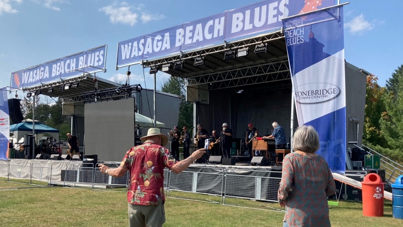 A band performs while a fan dances at the Stonebridge Wasaga Beach Blues Festival in Wasaga Beach, Ont on September 15, 2024 (CTV News/Chris Garry). 