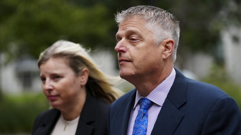 Former vice-admiral Haydn Edmundson, right, arrives to the courthouse in Ottawa on Wednesday, Aug. 28, 2024. THE CANADIAN PRESS/Sean Kilpatrick