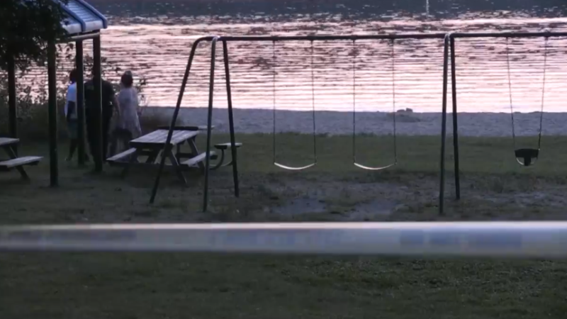 Yellow police tape blocks off an area at Huronia Park in Penetanguishene, Ont., on Sun., Sept. 15, 2024, as emergency crews search for a missing swimmer. (CTV News/Chris Garry) 