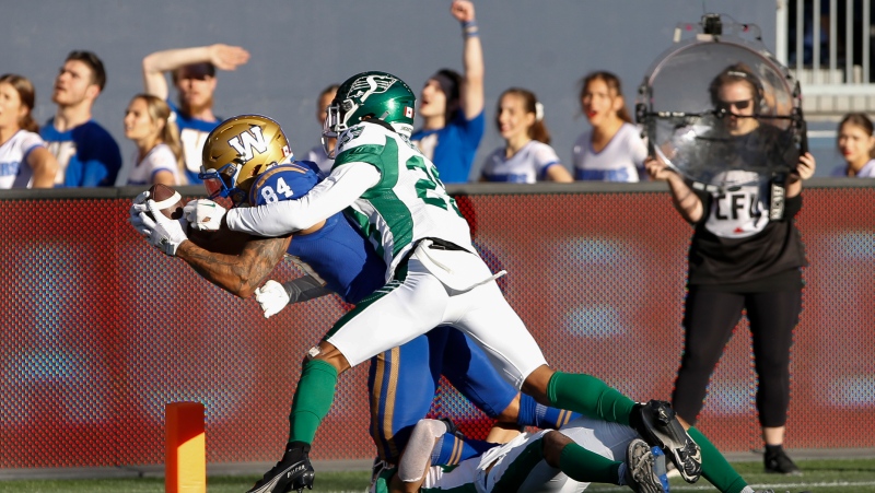 Winnipeg Blue Bombers' Brendan O’Leary-Orange (84) dives in for the touchdown against Saskatchewan Roughriders' Miles Brown (28) during the second half of CFL football action in Winnipeg Saturday, September 10, 2022. THE CANADIAN PRESS/John Woods