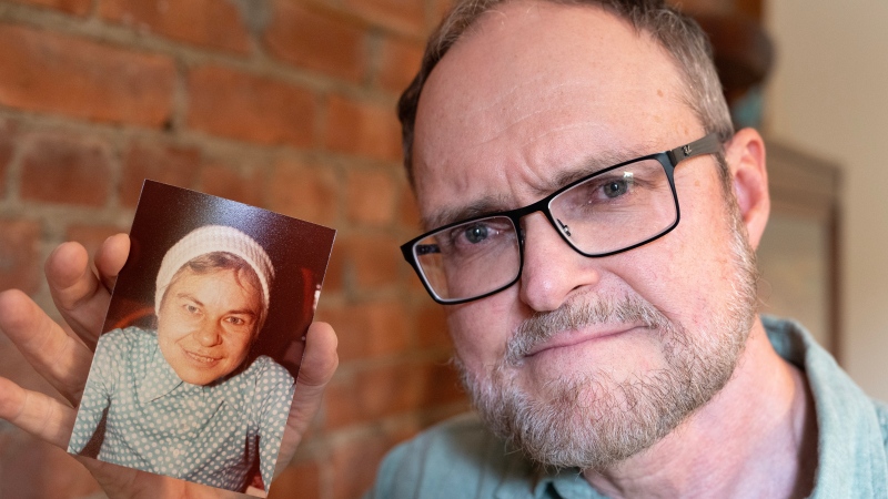 Glenn Landry holds up a picture of his mother, Catherine Harter, Thursday, Sept.12, 2024, in Montreal. Landry is part of a lawsuit alleging brainwashing experiments involving electroshock therapy. (THE CANADIAN PRESS/Ryan Remiorz)