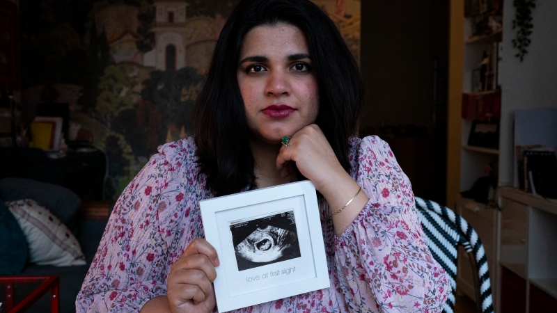 Sanniah Jabeen poses for a photograph holding a print of an ultrasound of her unborn baby boy Waleed who died after Sanniah contracted listeria, in Toronto, on Thursday, Sept. 5, 2024. (Arlyn McAdorey/The Canadian Press)
