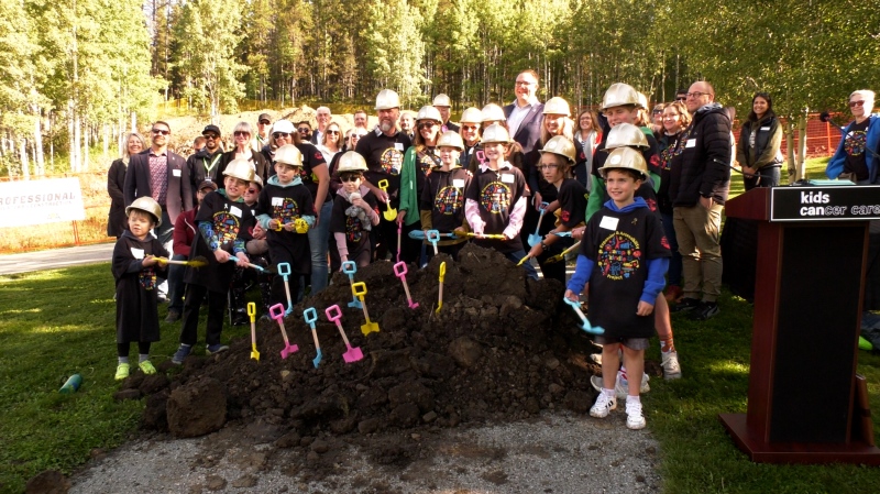 A group of dignitaries and campers celebrate the kick-off to an $8.9 million construction project at Camp Kindle near Water Valley, Alta. 