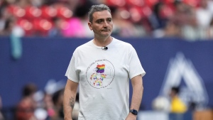 Vancouver Whitecaps head coach Vanni Sartini paces the sideline during the first half of an MLS soccer match against the Houston Dynamo, in Vancouver, on Saturday, July 20, 2024. (Darryl Dyck / The Canadian Press)