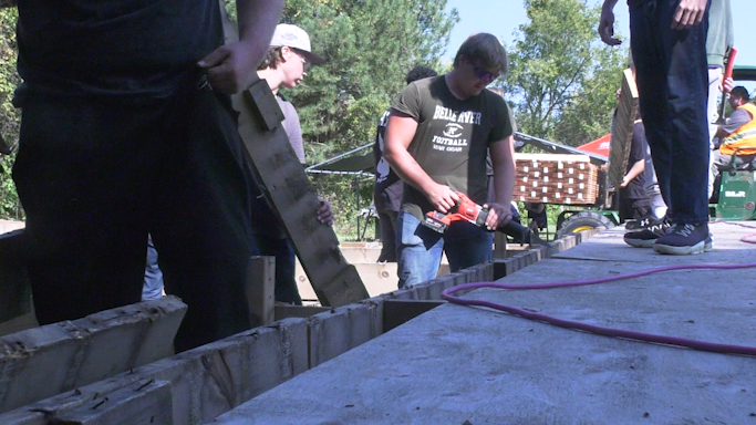 SHSM students work on the deck at the John Freeman Walls Historic Site and Underground Railroad Museum in Lakeshore, Ont. on Sept. 18, 2024. (Stefanie Masotti/CTV News Windsor)