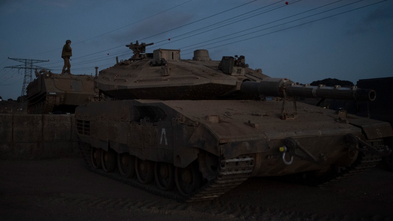 An Israeli soldier stands on the top an armored vehicle on an area in the Israeli-annexed Golan Heights, Thursday, Sept. 19, 2024. (AP Photo/Leo Correa)