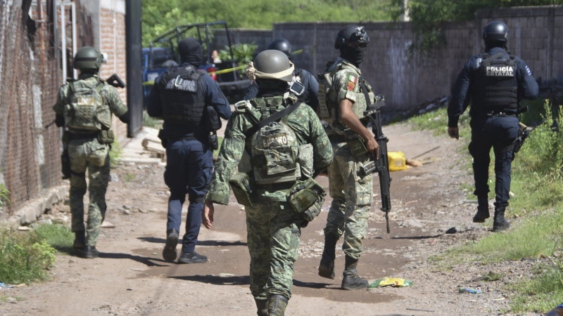 Soldiers and police arrive at the area where bodies lie on the ground in Culiacan, Sinaloa state, Mexico, Tuesday, Sept. 17, 2024. (AP Photo)