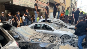 People gather at the scene of an Israeli missile strike in the southern suburbs of Beirut, Friday, Sept. 20, 2024. (Bilal Hussein / AP Photo)