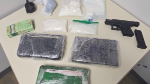 A search of the black Suburban uncovered a loaded 9 mm Glock handgun, ammunition, more than $1,200 in cash, cannabis, and more than four kilos of suspected cocaine and 2,400 hydromorphone tablets with a street value of about $300,000. (OPP photo)