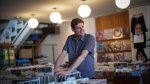 B.C. Premier David Eby pauses while browsing records for sale at Zulu Records before an interview with The Canadian Press, in Vancouver, on Wednesday, September 4, 2024. David Eby thumbs through a stack of vinyl records at Zulu Records located in his Vancouver-Point Grey riding and says he's reminded of his younger days working at a Sam The Record Man store over the Christmas holidays. (Darryl Dyck / The Canadian Press)