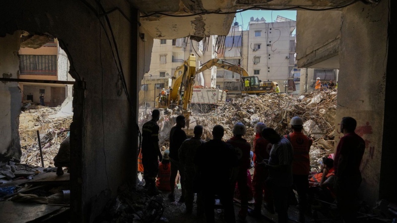 Emergency workers use excavators to clear the rubble at the site of Friday's Israeli strike in Beirut's southern suburbs, Lebanon, Monday, Sept. 23, 2024. (AP Photo/Hassan Ammar)