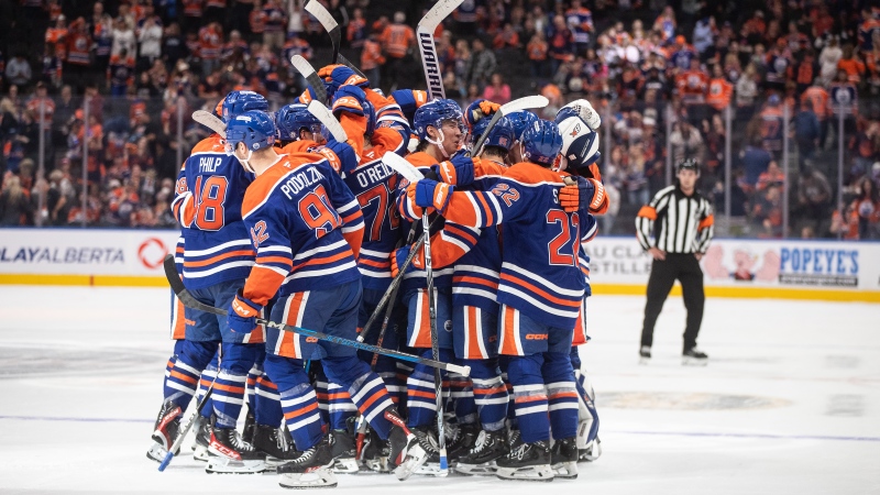 Edmonton Oilers players celebrate their overtime win over the Winnipeg Jets during NHL preseason action on Sept. 22, 2024, at Edmonton's Rogers Place. (Jason Franson/The Canadian Press)