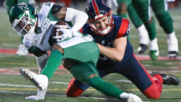 Montreal Alouettes' Joseph Zema, right, tackles Saskatchewan Roughriders' Marcus Sayles during first half CFL football action in Montreal, Thursday, July 25, 2024. THE CANADIAN PRESS/Graham Hughes