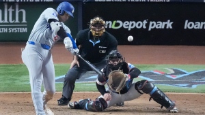 Los Angeles Dodgers' Shohei Ohtani (17) hits a home run scoring Andy Pages, during the seventh inning of a baseball game against the Miami Marlins, Thursday, Sept. 19, 2024, in Miami. (Wilfredo Lee / AP Photo)