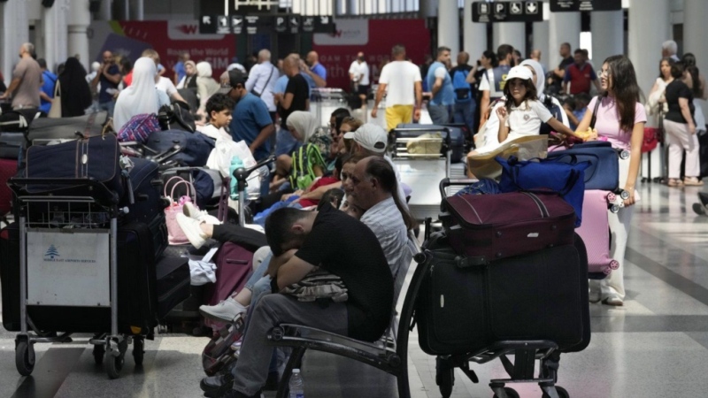 Passengers whose flights were cancelled, wait at the departure terminal of Rafik Hariri International Airport, in Beirut, Lebanon, on Monday, Aug. 5, 2024. Global Affairs Canada is booking up blocks of seats on some commercial flights leaving Lebanon to help Canadians trying to flee as Israeli strikes escalated Friday. THE CANADIAN PRESS/AP-Hussein Malla