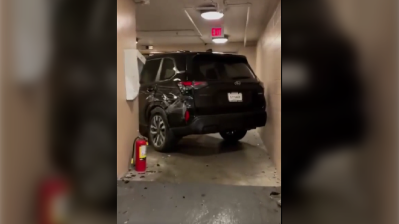 A video posted on social media shows an SUV wedged in a parkade hallway at the River Rock Casino in Richmond, B.C. (Courtesy: u/soupnazi81/Reddit) 