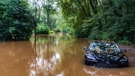 A partially submerged vehicle sits in flood water from after Hurricane Helene passed the area, Friday, Sept 27, 2024, in Atlanta. (ason Allen / AP Photo)