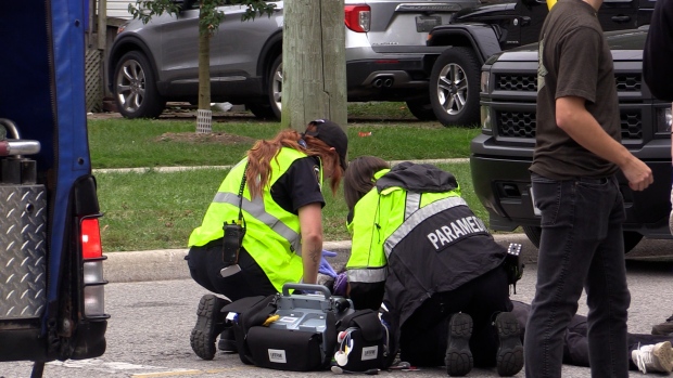 London Middlesex EMS assess a patient who took a hard fall on Huron St. during off campus Western Homecoming festivities (Brent Lale/CTV News London)