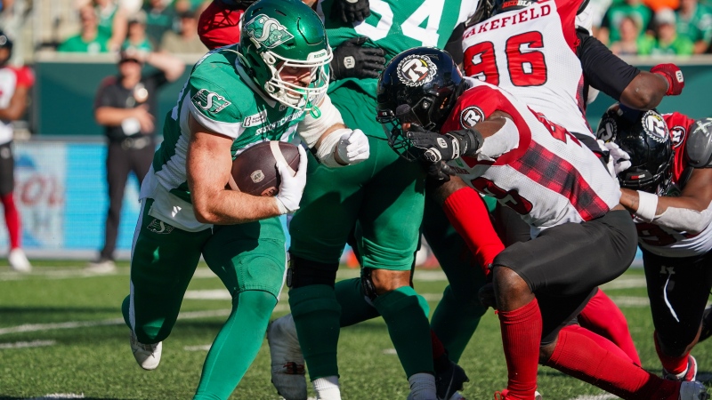 Saskatchewan Roughriders running back Thomas Bertrand-Hudon (left) runs the football as Ottawa Redblacks linebacker Davion Taylor (43) defends during the second half of CFL football action in Regina, on Saturday, September 28, 2024. THE CANADIAN PRESS/Heywood Yu