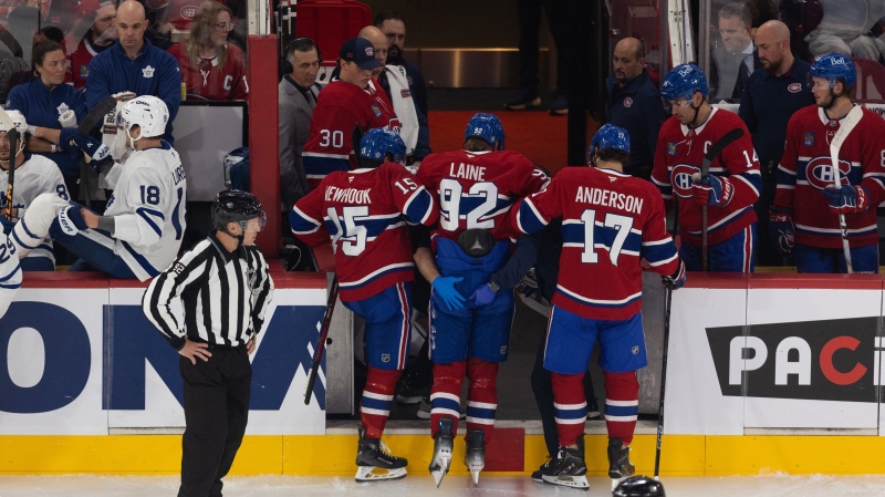 Montreal Canadiens' Patrik Laine (92) is helped off the ice by teammates following a collision with a Toronto Maple Leas player during first period NHL pre-season action in Montreal, Saturday, Sept. 28, 2024. THE CANADIAN PRESS/Evan Buhler