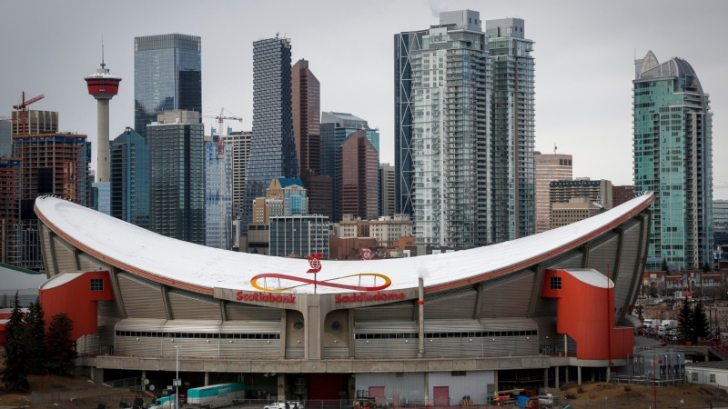 The city skyline is seen behind the Saddledome, home of the Calgary Flames, in Calgary, Alta., Thursday, March 12, 2020. (THE CANADIAN PRESS/Jeff McIntosh)