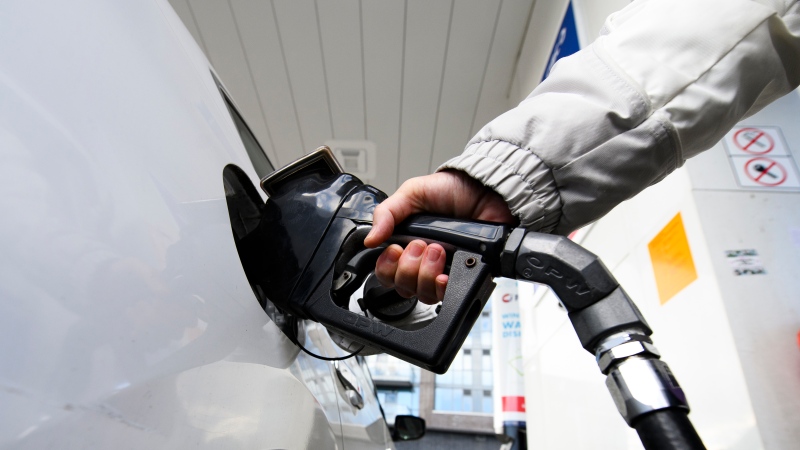 A person pumps gas at a gas station in Mississauga, Ont., on Feb. 13, 2024. (Christopher Katsarov / The Canadian Press)