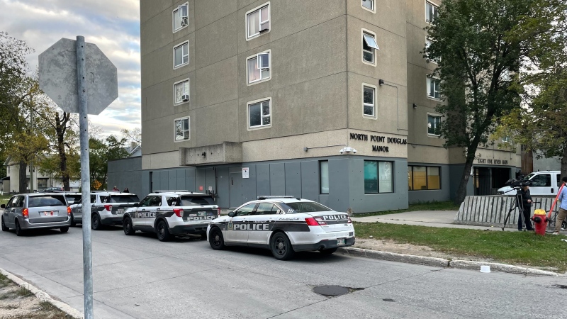 Winnipeg police vehicles respond to the scene of an officer-involved shooting at an apartment building on Main Street on Oct. 2, 2024. Manitoba's police watchdog is investigating after a man armed with edged weapons was fatally shot by a Winnipeg police officer. (Jamie Dowsett/CTV News Winnipeg)