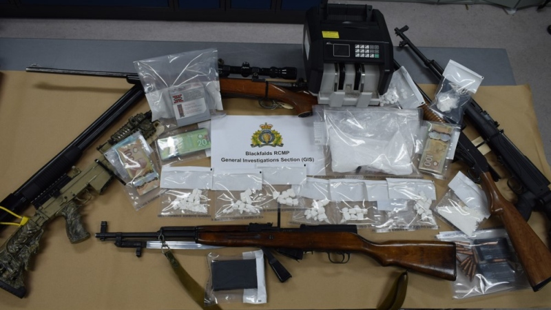 A woman was arrested after six guns, 253 grams of cocaine and more than $3,300 is cash were seized from a Blackfalds home on Oct. 2. (Supplied)