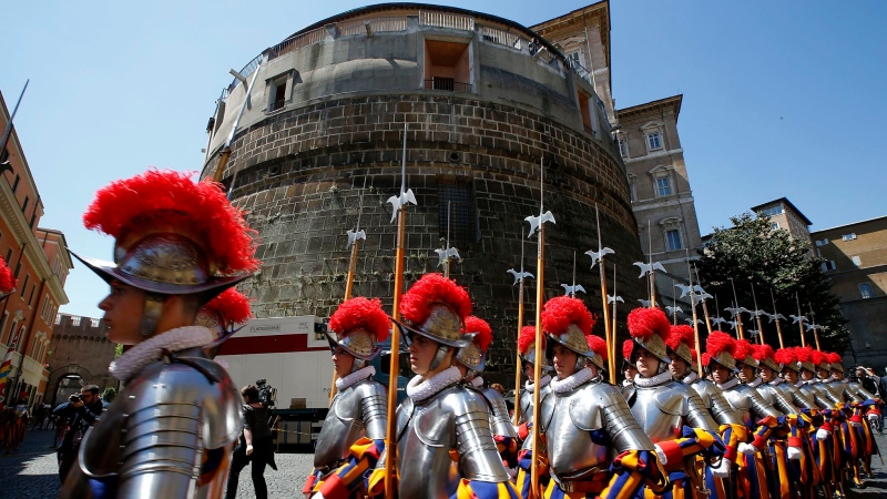 Members of the Vatican's elite Swiss Guard march in front of the Institute for the Works of Religion (IOR). Tony Gentile/Reuters via CNN Newsource