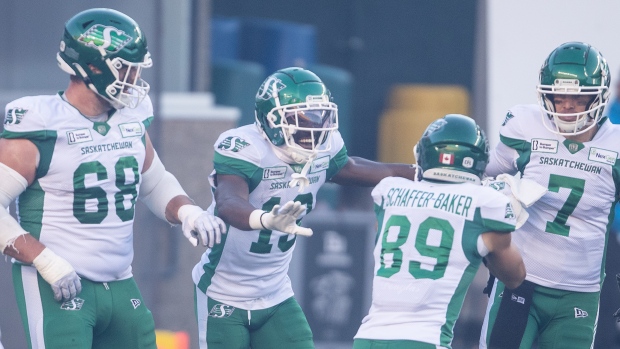 Saskatchewan Roughriders' Samuel Emilus (second left) celebrates a touchdown with Noah Zerr (68), Kian Schaffer-Baker (89) and quarterback Trevor Harris (7) against the Edmonton Elks during first half CFL action in Edmonton, on Saturday October 5, 2024. THE CANADIAN PRESS/Jason Franson