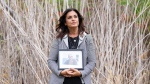 Raquel Ohnona Look holds a photograph of her son Alexandre Look, in the park named after him in Montreal, Tuesday, Oct. 1, 2024. Look was killed on October 7, 2023 in the Hamas attack at a music festival in Israel. THE CANADIAN PRESS/Christinne Muschi