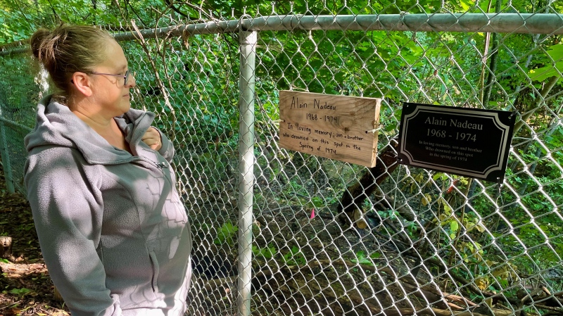 Guylaine Nadeau looks a plaque commemorating her six-year-old brother who drowned in a creek in 1974. (Denise Roberts/CTV News)