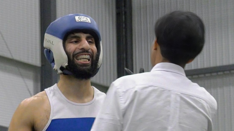 A referee checks a boxer's mouthguard at the 2024 Ontario Boxing Golden Gloves Provincial Championship in Windsor, Ont., on Oct. 3, 2024. (Sanjay Maru/CTV News Windsor)