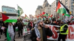 A pro-Palestinian protester leads a chant during a protest on Parliament Hill in Ottawa, on Saturday, Nov. 25, 2023. THE CANADIAN PRESS/Spencer Colby