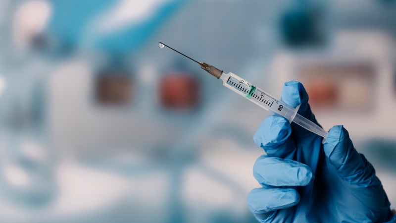 A gloved hand holds a syringe in this undated file image (IMAGINESTOCK / Getty Images)