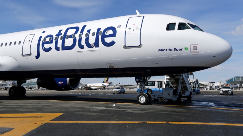 A JetBlue airplane sits on the tarmac at John F. Kennedy International Airport in New York in 2017. JetBlue’s economy class passengers will no longer find hot meals on the menu aboard transatlantic flights. (Seth Wenig/AP via CNN Newsource)
